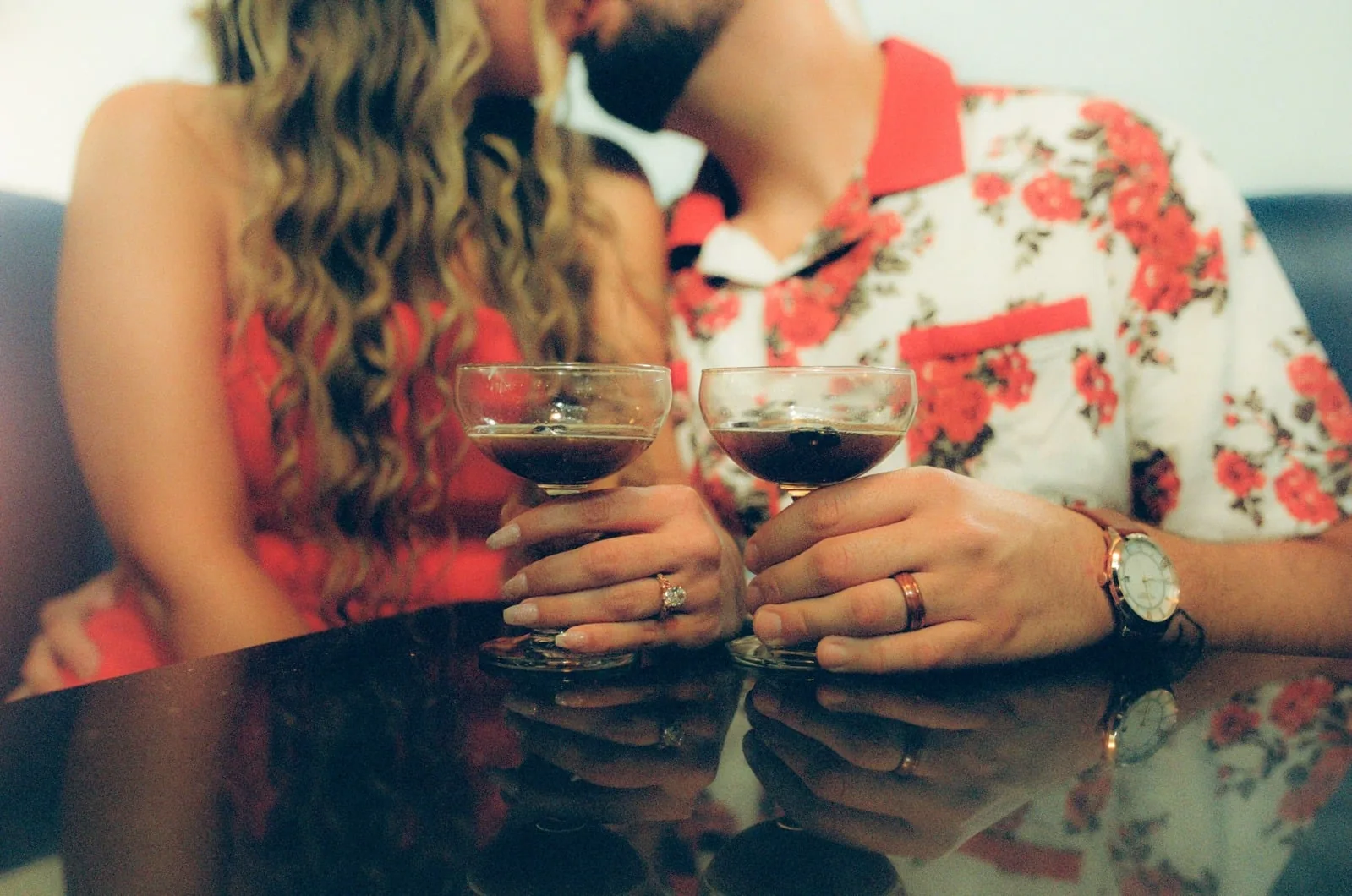 Two glasses raised together at the bar